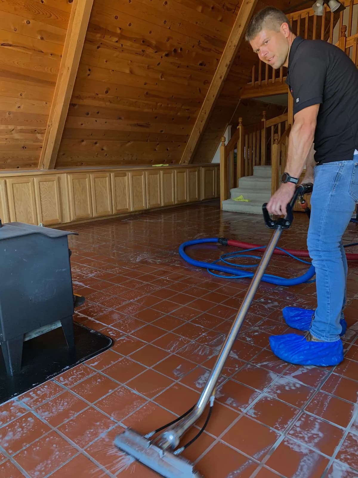 A Freedom Cleaning technician deep-cleaning a tile floor